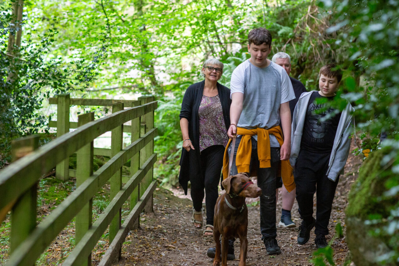 family taking dog for a walk