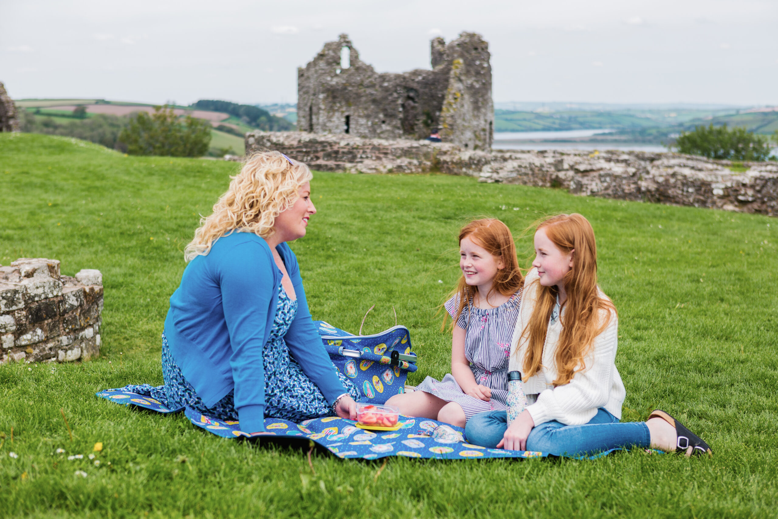 Mum, and two girls having a picnic