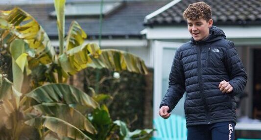Boy playing football in the garden