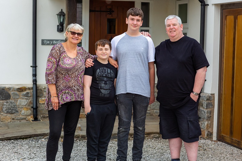 Family at front door of house